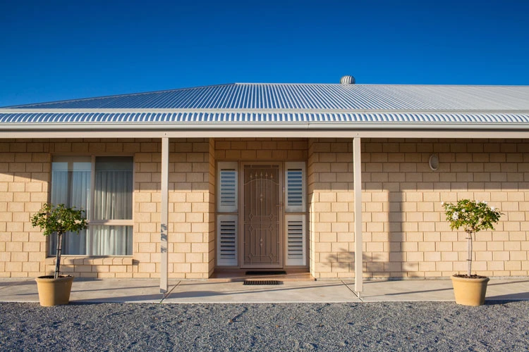 How does the cost of a concrete house compare to a brick house?