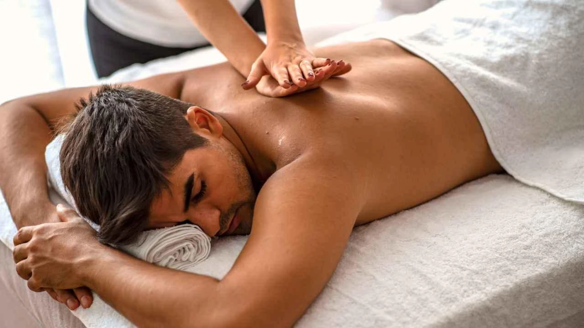 A person lying down on a massage table
AI-generated content may be incorrect.